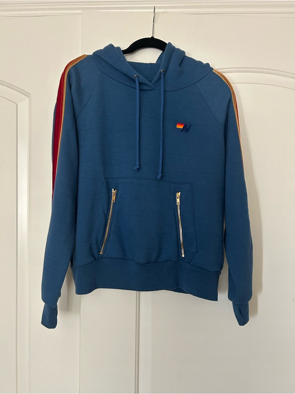 Aviator Nation blue pullover Hoodie. Velvet stripe sleeve with zipper pockets.
